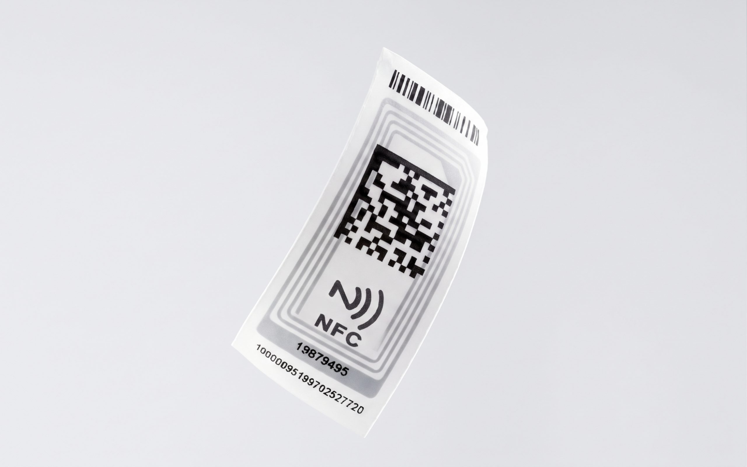 NFC satin polyester label with a QR code, NFC logo, barcode and ID number printed on it.